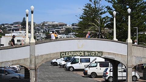 Members of the public cross a walk bridge at the scene of last Sunday's shooting after it was reopened to the public at Bondi Beach in Sydney, Thursday, Dec. 18, 2025.