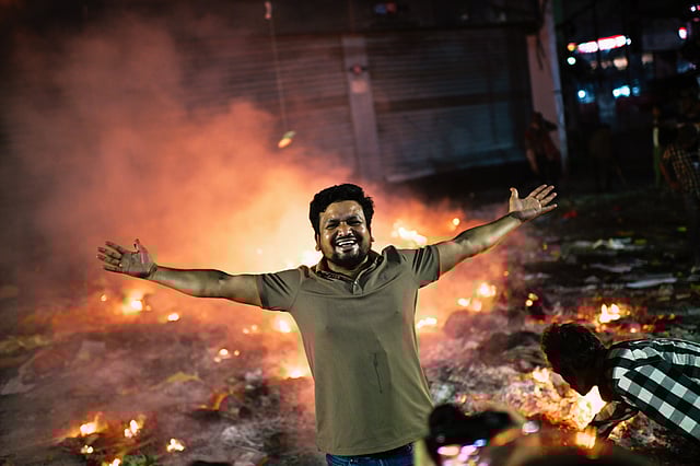 A protester reacts to the camera near the premises of the Prothom Alo daily newspaper, which was set on fire by angry protesters after news reached the country from Singapore of the death of a prominent activist, Sharif Osman Hadi, in Dhaka, Bangladesh, Friday, Dec. 19, 2025.