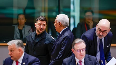 Ukraine's President Volodymyr Zelenskyy, second left, speaks with European Council President Antonio Costa, center rear, during a round table meeting at the EU Summit in Brussels, Thursday, Dec. 18, 2025.