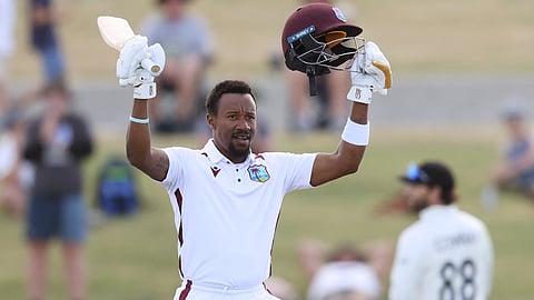 West Indies' Kavem Hodge celebrates his century during day three of the 3rd international Test cricket match between New Zealand and West Indies at Bay Oval in Mount Maunganui on December 20, 2025.