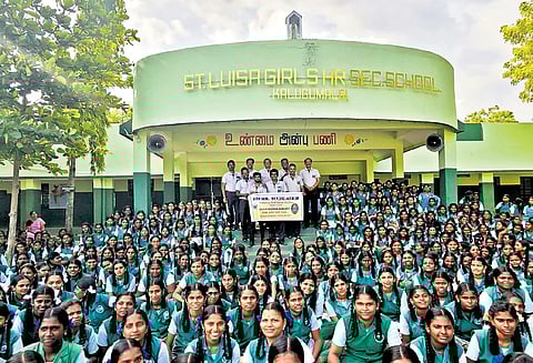Students of St Luisa Higher Secondary School in Kalugumalai hold a banner of Nighileswaran’s life skill programme.
