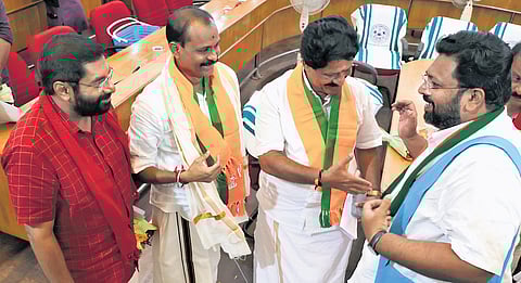 LDF councillor S P Deepak, NDA councillors V V Rajesh and M R Gopan and UDF councillor K Sabarinadhan greeting each other after swearing-in ceremony