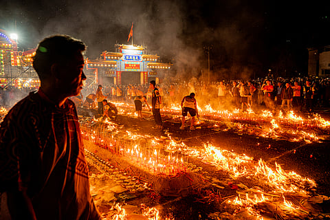 People burn incense sticks while offering prayers during the decennial Jiao Festival of Kam Tin in Hong Kong.