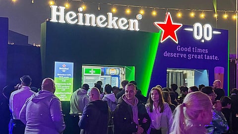 Festivalgoers gather near food and beverage stands, including a booth serving nonalcoholic beer, during the Soundstorm music festival in Riyadh, Saudi Arabia, Thursday, Dec. 11, 2025.