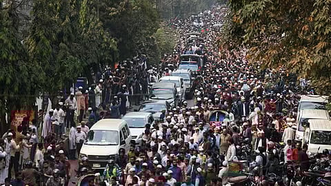 People rally along a vehicle carrying the body of youth leader Sharif Osman Hadi while being taken for burial in Dhaka on Saturday