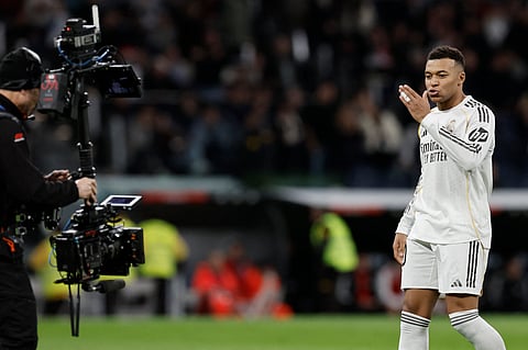 Real Madrid's French forward #10 Kylian Mbappe celebrates scoring his team's second goal during the Spanish league football match between Real Madrid CF and Sevilla FC at Santiago Bernabeu Stadium in Madrid on December 20, 2025.