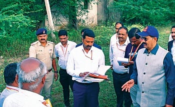 Upa Lokayukta Justice B Veerappa visits under-construction houses in which plants and trees have grown.