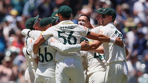 Australia's players celebrate after winning the third Ashes Test against England in Adelaide, Australia on Sunday.