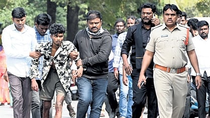 A youth, who attacked a CI, being whisked away in Anantapur