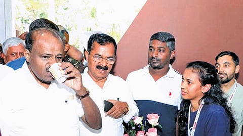 Union Minister HD Kumaraswamy tastes coffee at the centenary celebrations of Central Coffee Research Institute at Balehonnur on Monday.