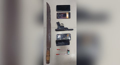Weapons and other items seized from the two accused.