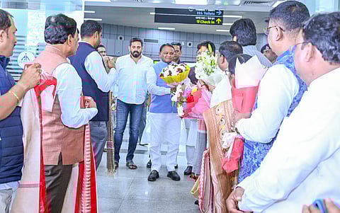 Chief Minister Mohan Charan Majhi is given a warn welcome by his cabinet colleagues and BJP MLAs at the airport after his return from Hyderabad.