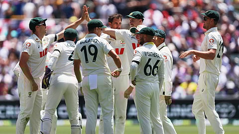 Australian players celebrate the dismissal of England's Jamie Smith during play on the final day of the third Ashes cricket.