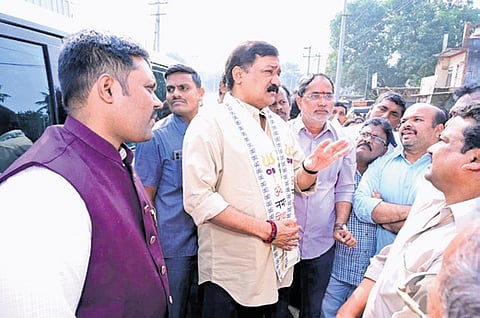 Bheemili MLA Ganta Srinivasa Rao interacting with affected TDR holders at Old Adavivaram Junction in Simhachalam on Tuesday.