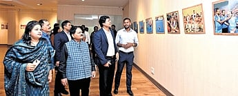 Dilip Tirkey is going round the photo exhibition at the State Museum 