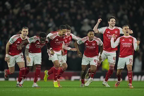 Arsenal players celebrate after winning in a penalty shootout the English Football League Cup quarter-final soccer match between Arsenal and Crystal Palace in London, Tuesday, Dec. 23, 2025.