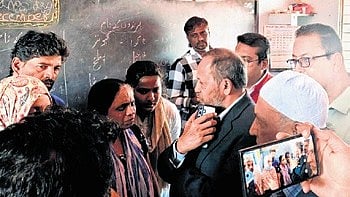 Minority Commission Chairman U Nisar Ahmed interacts with residents of Fakeer Layout on Wednesday.