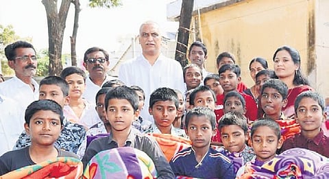 Former Minister Harish Rao distributes blankets to students in Nasarpura residential School in Siddipet constituency on Thursday.