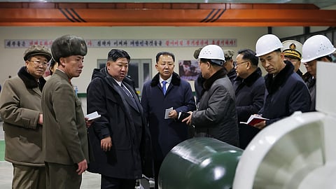 In this undated photo provided Thursday, Dec. 25, 2025, by the North Korean government, its leader Kim Jong Un, third left, visits a shipyard as he inspects a nuclear-powered submarine under construction at an undisclosed location in North Korea.