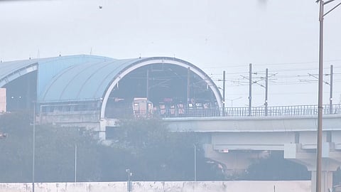 A Metro train passes through the smog at Akshardham in New Delhi as air quality deteriorates to the 'very poor' category across the national capital.