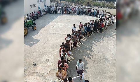 Farmers rush to the fertiliser depot at the Maripeda Primary Agricultural Cooperative Society (PACS) to collect urea bags for the Rabi season in Mahabubabad district on Thursday.