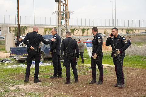 In this photo released by Israel Police on Friday, Dec. 26, 2025, Israeli police officers work on the site where a vehicle was used, according to the authorities, during a suspected ramming and stabbing attack in Afula, northern Israel. 