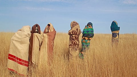 Xhosa boys stand in a field during traditional Xhosa male circumcision ceremonies into manhood in Qunu, South Africa, on Saturday, June 30, 2013.