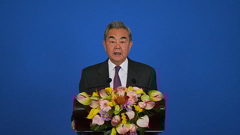 China's Foreign Minister Wang Yi delivers an opening speech on stage for the annual symposium on the international situation and China's foreign relations held by the China Institute of International Studies at the Diaoyutai State Guesthouse, in Beijing, Tuesday, Dec. 30, 2025.