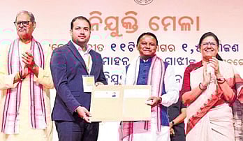 CM Mohan Charan Majhi handing over appointment letter to a new recruit at the State Employment Fair on Tuesday