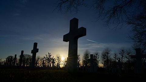 The sun sets over the graves of more than 8,300 WWII soldiers at the Netherlands American Cemetery in Margraten, Netherlands, Thursday, Dec. 11, 2025, where the American Battle Monuments Commission removed two displays honoring Black liberators from the visitors center.
