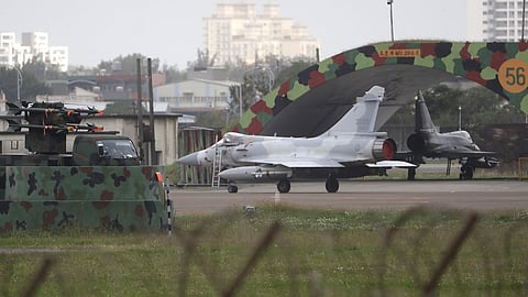 A Taiwanese Mirage 2000 fighter jet moves past airplane fort at an airbase in Hsinchu, northern Taiwan, Tuesday, Dec. 30, 2025.