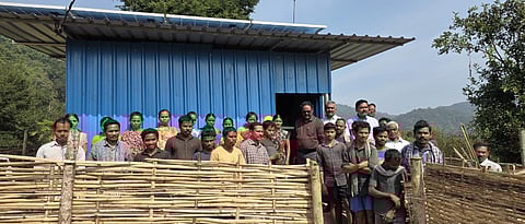 Tribals along with the members of National Commission for Scheduled Tribes near the solar microgrid at the remote Modela village