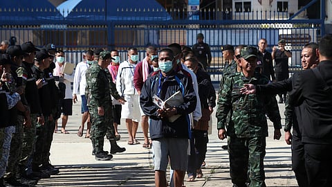 Cambodian soldiers, center, arrive after being captured and held by the Thai army, at Prum border gate, in Pailin province, Cambodia, Wednesday, Dec. 31, 2025.