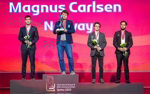 Magnus Carlsen (second left) with the world blitz trophy. Indian Grandmaster Arjun Erigaisi (first from right) won the bronze medal in the World Blitz Championship.