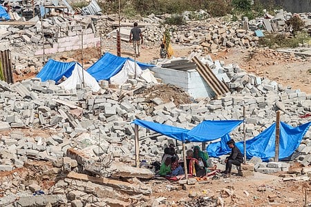 People stay at make-shift tents, amidst the rubble caused by the demolition drive by BSWML at Kogilu Layout
