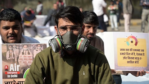 Demonstrator wearing an oxygen mask protests demanding governments action to reduce air pollution in New Delhi on Wednesday.