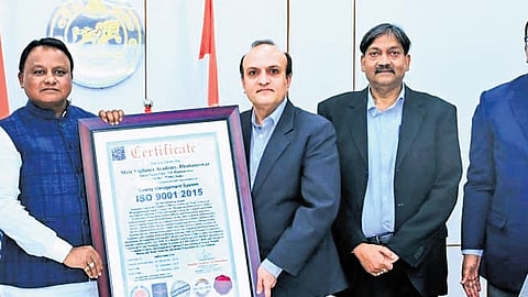 Vigilance DG Yashwant Jethwa presenting the ISO  9001:2015 certification received by State Vigilance Academy for quality training and management standards to CM Mohan Charan Majhi.