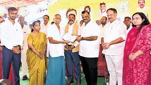 Revenue Minister Anagani Satya Prasad launching the new Pattadar Passbook distribution programme at Donepudi in Bapatla district on Friday 