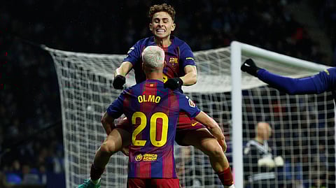 Barcelona's Dani Olmo (20) is congratulated by Fermin Lopez after scoring his side's opening goal during the Spanish La Liga soccer match between RCD Espanyol and Barcelona in Barcelona, Spain, Saturday, Jan. 3, 2026. 