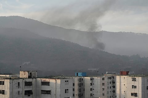 Smoke rises from Fort Tiuna, the main military garrison in Caracas, Venezuela, after multiple explosions were heard and aircraft swept through the area, Saturday, Jan. 3, 2026. 
