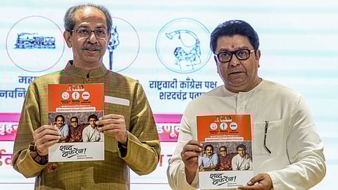 Shiv Sena (UBT) chief Uddhav Thackeray, left, and Maharashtra Navnirman Sena (MNS) chief Raj Thackeray release their alliance manifesto for the upcoming civic polls, at Sena Bhavan, in Mumbai, Sunday, Jan. 4, 2026.