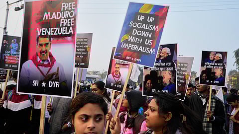 Activists during a rally in Kolkata with posters during a protest against a U.S. military operation in Venezuela.