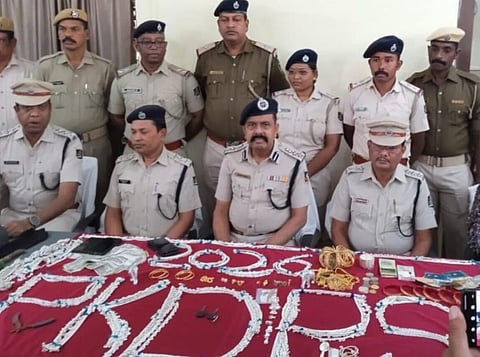 Police with the stolen items and cash recovered from the accused | Express