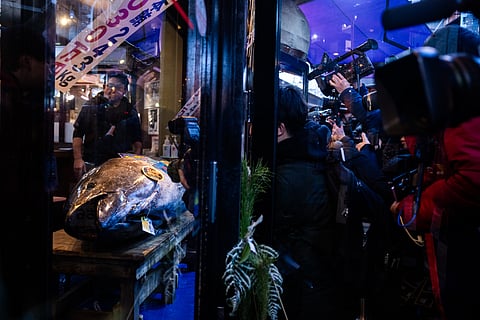 Members of the press take photographs of a bluefin tuna that won the highest bid at the annual New Year auction displayed at Sushi Zanmai restaurant in Tokyo, Monday, Jan. 5, 2026