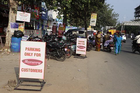  A shopkeeper illegally blocking parking spots on the Tiruchy road in Coimbatore on Monday.