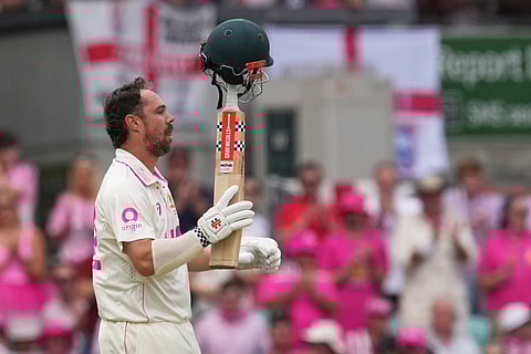 Australia's Travis Head celebrates after scoring a century during play on day three of the fifth and final Ashes cricket test between England and Australia in Sydney.