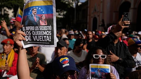 Venezuelan protesters hold posters that read in Spanish, "The empire kidnapped them; we want them back," during a protest demanding President Nicolas Maduro and first lady Cilia Flores' release from US custody in Caracas, Venezuela, Sunday, Jan. 4, 2026.