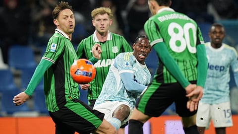 Juventus' Jonathan David battles for the ball with Sassuolo's Nemanja Matic, left, and Tarik Muharemovic during the Serie A soccer match between Sassuolo and Juventus, in Reggio Emilia, Italy, Tuesday, Jan. 6, 2026.