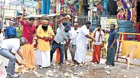 Welcoming the verdict, petitioner Rama Ravikumar along with members of Hindu outfits break coconuts in front of the Thiruparankundram temple on Tuesday.