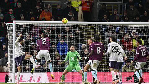 Manchester United's Matheus Cunha (L) heads the ball toward the goal but sees the effort cleared off the line during the English Premier League football match between Burnley and Manchester United on January 7, 2026.